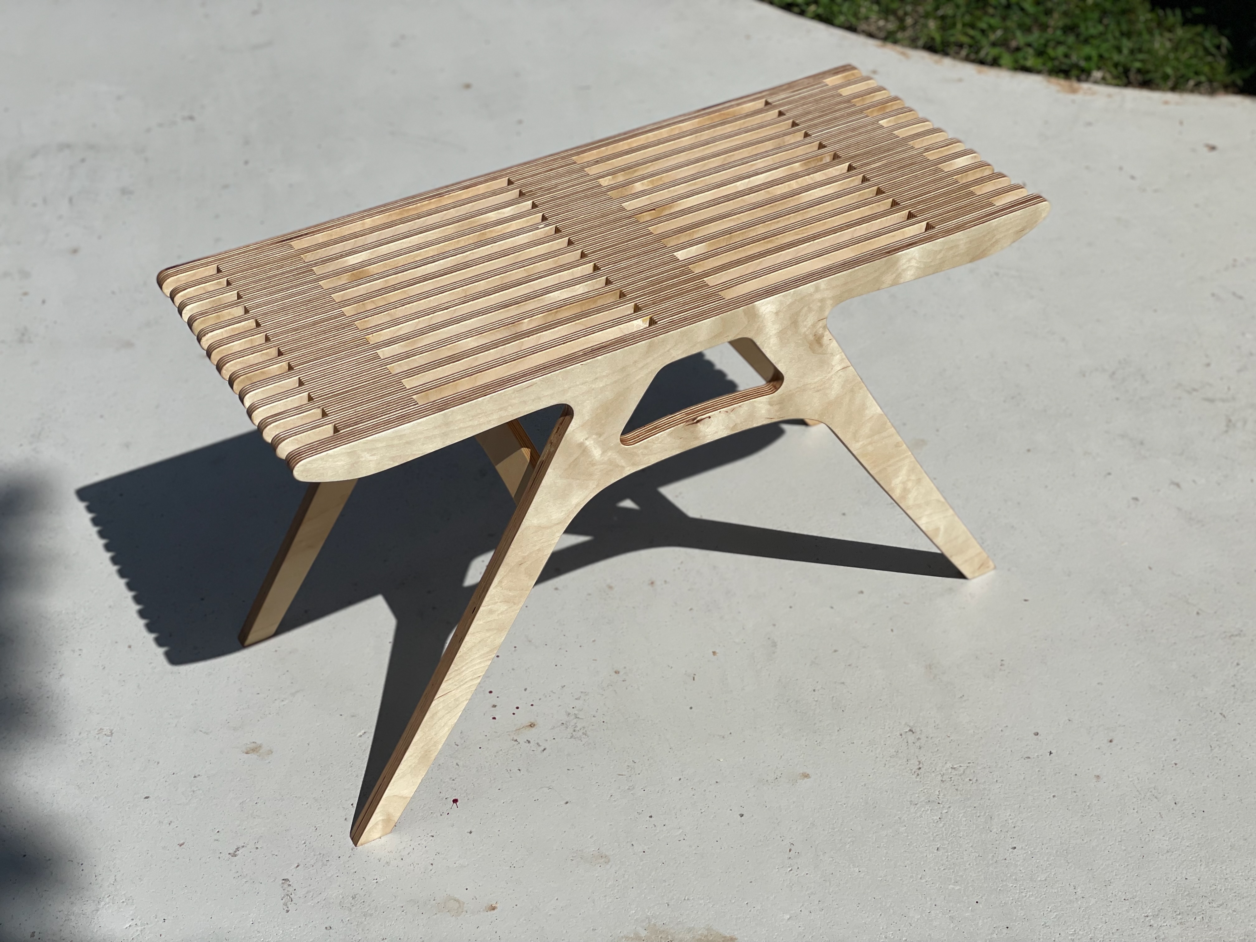 Slatted plywood bench with angled legs