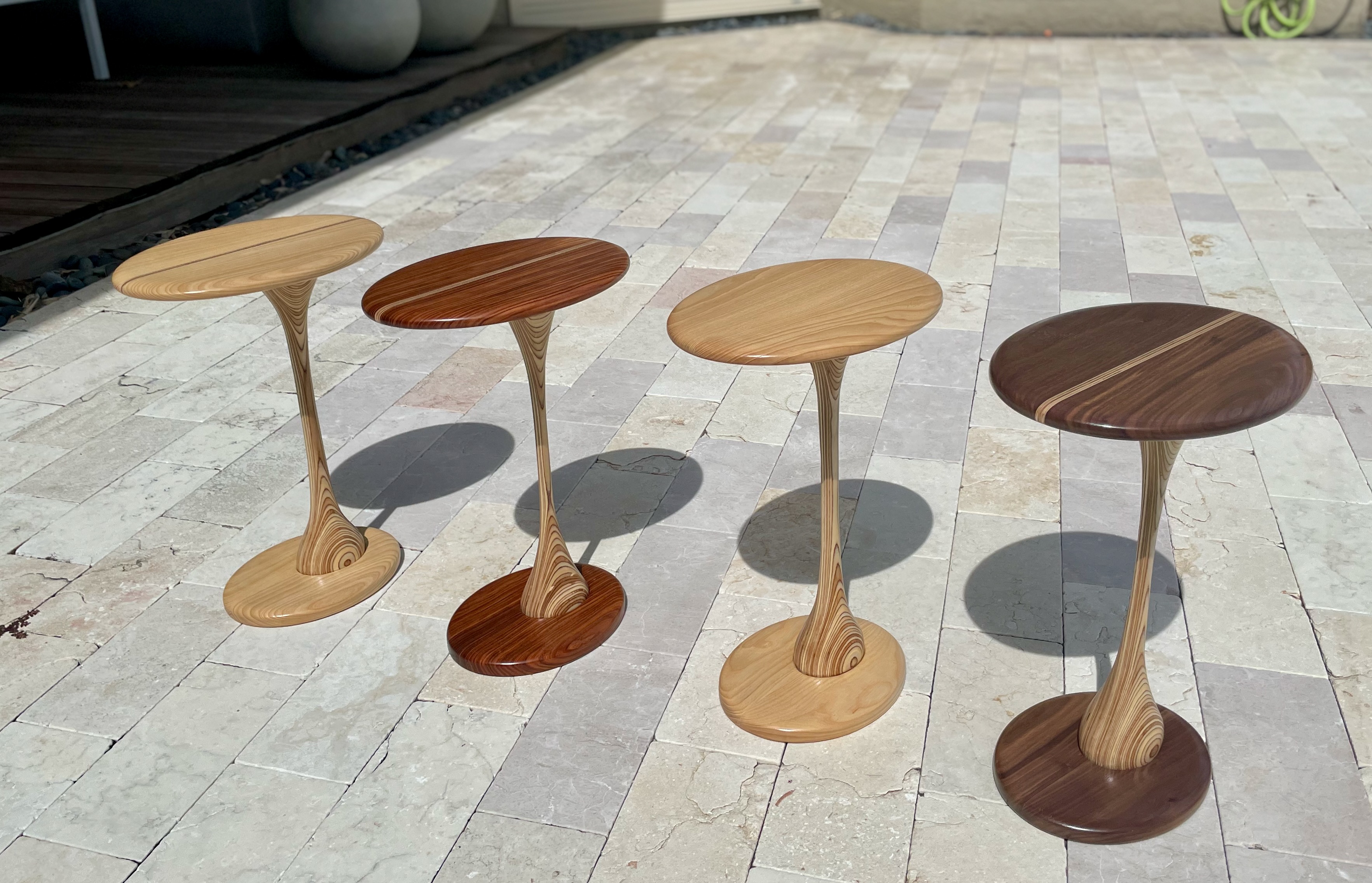 Four tulip pedestal tables — top view showing grain detail