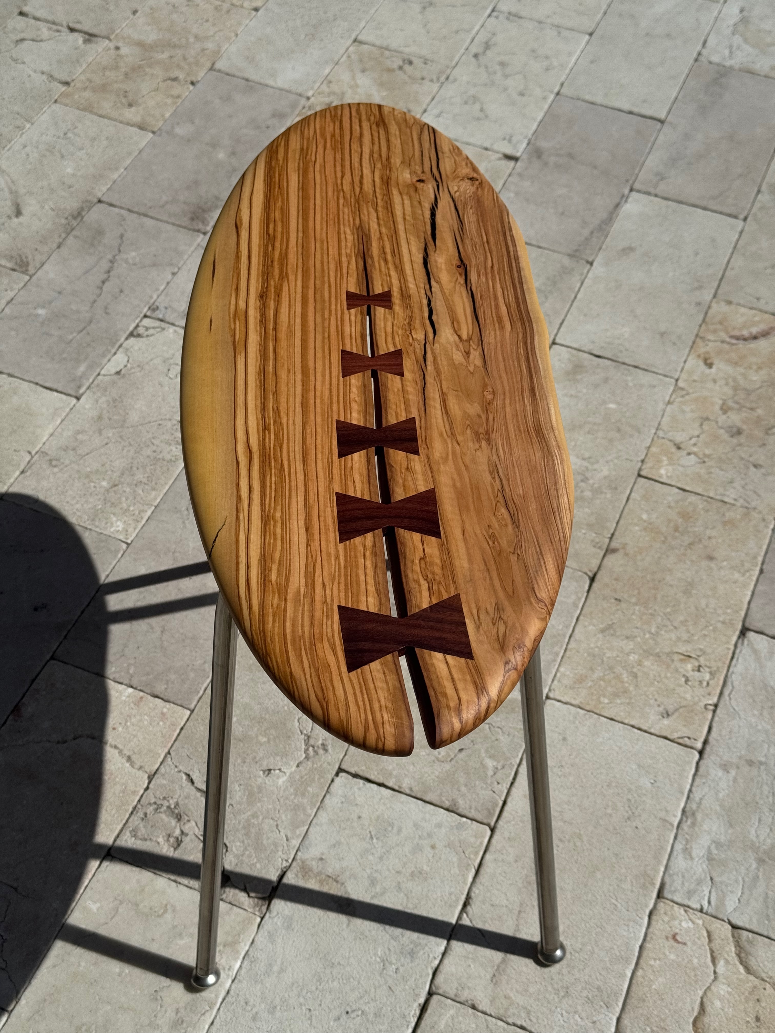 Zebrawood table top — bow-tie walnut inlays detail